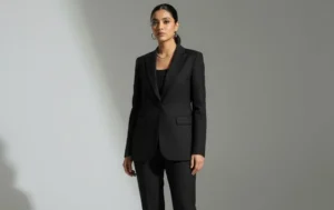 Modern power dressing: woman in a sleek monochrome black pantsuit and loafers.