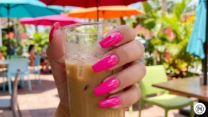 1. Hot Pink Power Nails Alt Text: Close-up of vibrant glossy hot pink coffin-shaped nails, a top trend for Summer 2026. 
