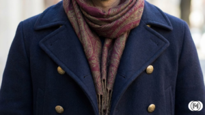 Creative winter layering featuring a thick grey wool cardigan over a black silk slip dress.