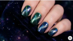10. Cat Eye Nails 2.0 Alt Text: Magnetic cat eye nails in emerald green with shimmering holographic effects. 