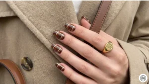 11. Rich Brown Plaid Nails Alt Text: intricate rich brown plaid nail art pattern for a chic and textured look. 