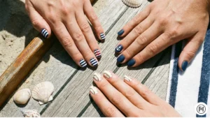 Nautical-Inspired: Beachy short nail designs featuring navy blue stripes, anchors, and nautical elements.
