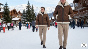 Creative winter layering featuring a thick grey wool cardigan over a black silk slip dress.