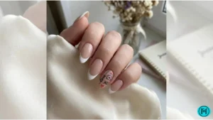 French tip nails featuring tiny love letters and 'XO' designs on accent nails.