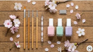 15Nail Art ToolsFlatlay of essential spring nail art tools including brushes, dotting tools, and pastel polish bottles.