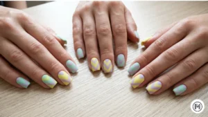 Alt Text: Geometric chevron pattern acrylic nails in soft spring pastel shades.