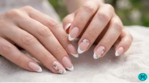 Almond-shaped nails with soft pink French tips and a polished finish.