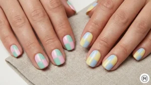 18. Checkerboard Revival: "Trendy pastel checkerboard nail pattern in mint green and lilac color blocks."