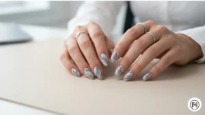 Alt Text: Minimalist grey and white marble acrylic nails with sleek silver metallic lines.
