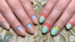 20. Half-Moon Art: "Vintage half-moon nail art with white and neon yellow crescent shapes at the base."