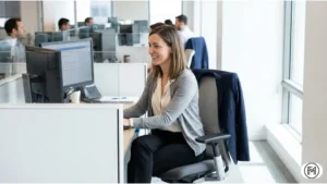 Lightweight grey cardigan over a silk blouse suitable for temperature-changing office environments.