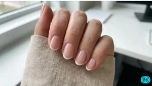 French tip nails with pink glitter fading from the tips to the base.