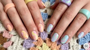 24. Vintage 70s Swirls: "Groovy 70s psychedelic swirl nail design in muted pastel spring colors."
