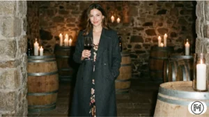 Elegant winter winery outfit featuring a long charcoal wool coat over a silk midi dress.