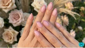 Nails with bold red French tips on a nude base, perfect for romantic looks.