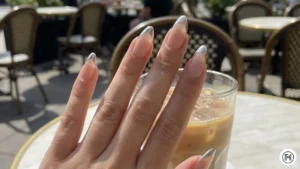 4. Modern French Tips Alt Text: Modern French manicure with metallic gold tips on short natural nails. 