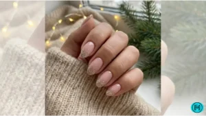 French tip nails with subtle pink glitter applied only on the tips.