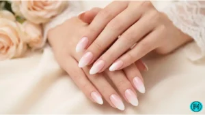 French tip nails featuring a thin gold line along white tips for a luxurious look.