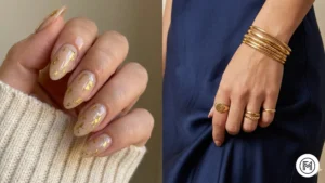 Gold Foil Accents: "Glamorous neutral nails with gold foil flakes and matching gold jewelry accents."