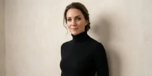 Portrait of the same woman against a textured beige wall, wearing a black cashmere turtleneck, looking at the camera.
