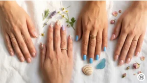 IMG 19 Four hands showing spring nail colors and art to match different aesthetics — nude, floral art, French tip, and pastel blue