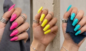 Matte neon pink, yellow, and turquoise nails featuring a glossy, raised 3D crocodile skin texture.