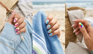 Hands displaying vibrant tie-dye watercolor splash nail art using blooming gel over a white base.