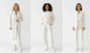 Three women showcasing all-white winter monochromatic outfits featuring a heavy wool coat, silk slip skirt, chunky knit sweater, and tailored white suit.