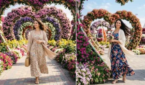 Two women in elegant floral maxi dresses with pashmina shawls, posing in the Dubai Miracle Garden.