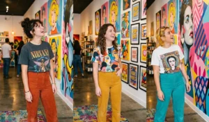 "Women wearing vintage graphic art t-shirts and bold high-waisted corduroy pants in an indie, eclectic pop-art museum exhibit."