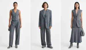 Three women wearing slate grey monochromatic outfits with sharp tailoring, featuring a fitted waistcoat, oversized blazer, and pleated wide-leg trousers.