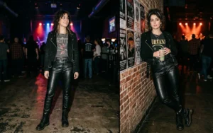 "Two women at a live music venue wearing faux leather pants, vintage graphic tees, and cropped moto jackets."
